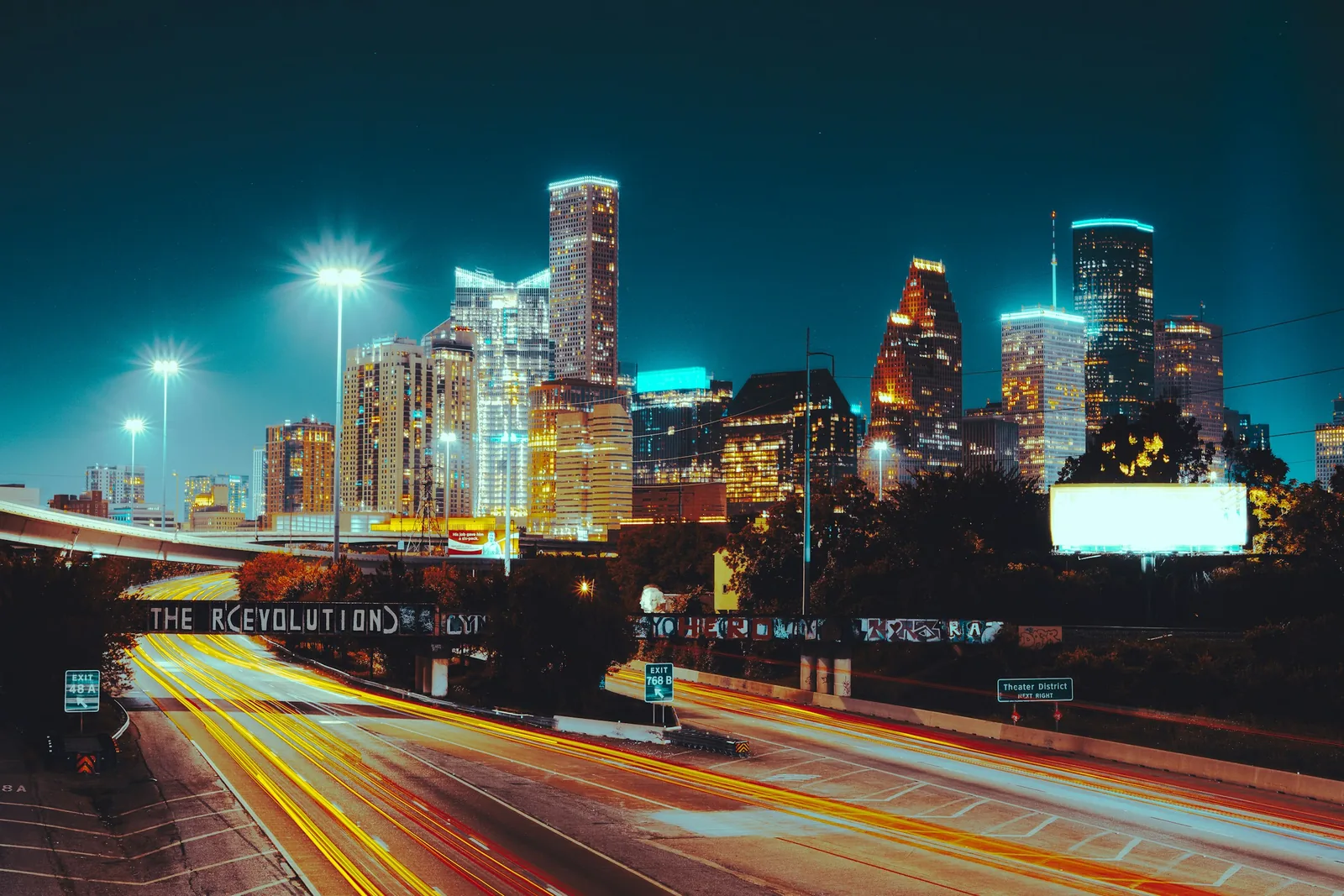 Wide Houston skyline at night with light trails